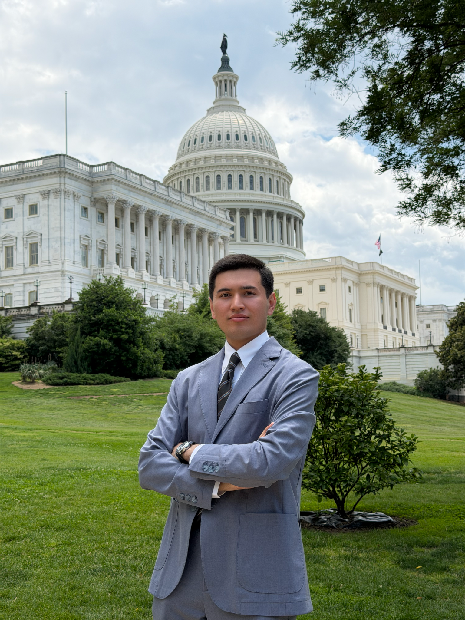 Mehrojbek Makhmudov standing in front of the United States Capitol in Washington, D.C.