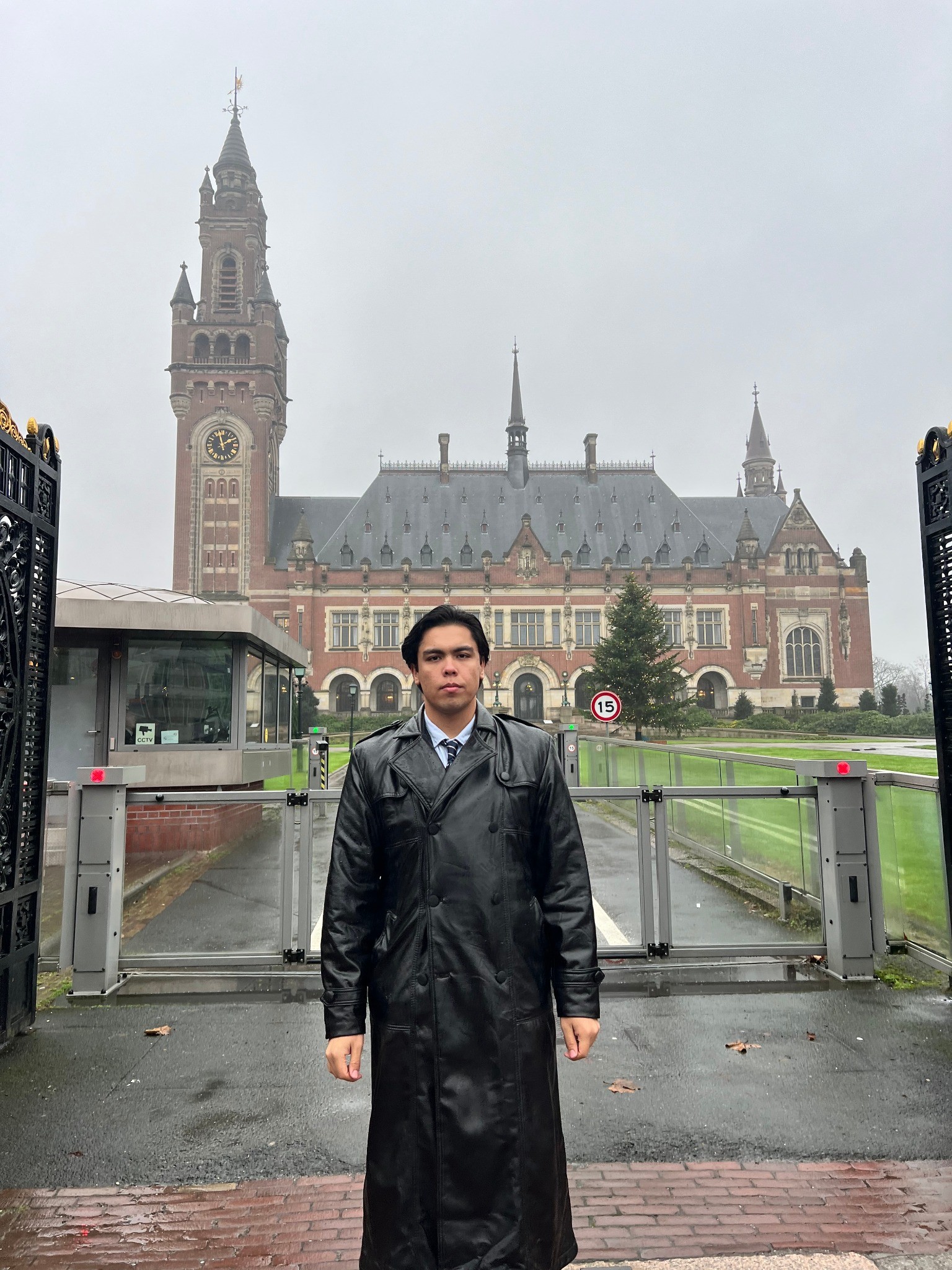 Ulugbek Kodirov standing before the Peace Palace in The Hague.